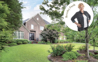 Brown brick three story home with large landscaped front yard image of Beverly Fasth over the image