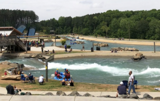 Charlotte white water center with people on rafts and trees in background